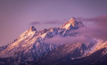 Colorful mountain peak covered by snow and cloud of Grand Teton National Park, Wyoming, USA at sunrise.